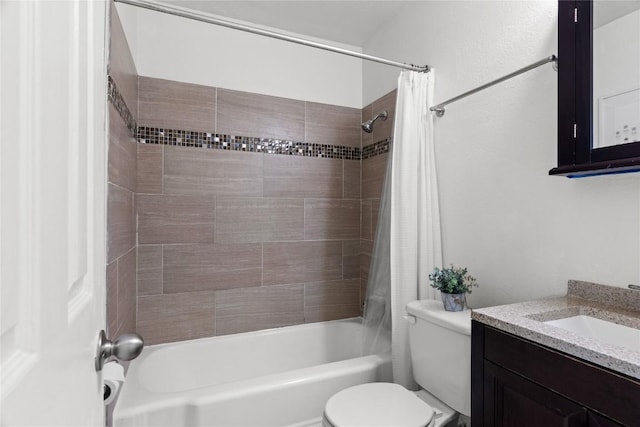 full bathroom with vanity, shower / tub combo, and toilet