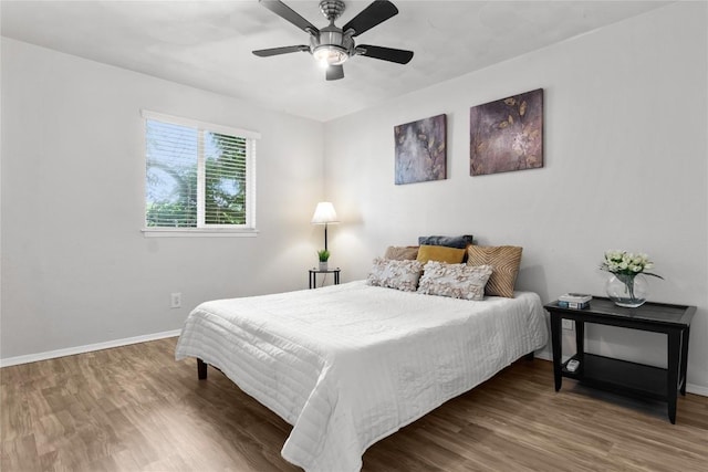 bedroom with wood-type flooring and ceiling fan