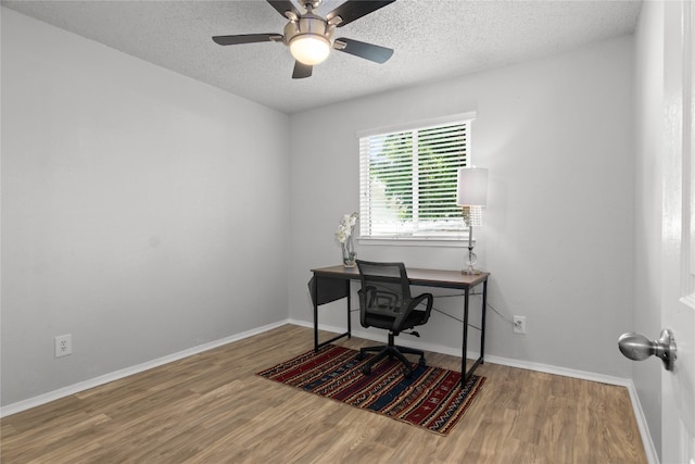 home office featuring ceiling fan, a textured ceiling, and hardwood / wood-style flooring