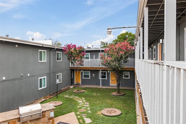 view of yard featuring a patio and exterior kitchen