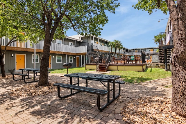 view of community featuring a yard and a deck