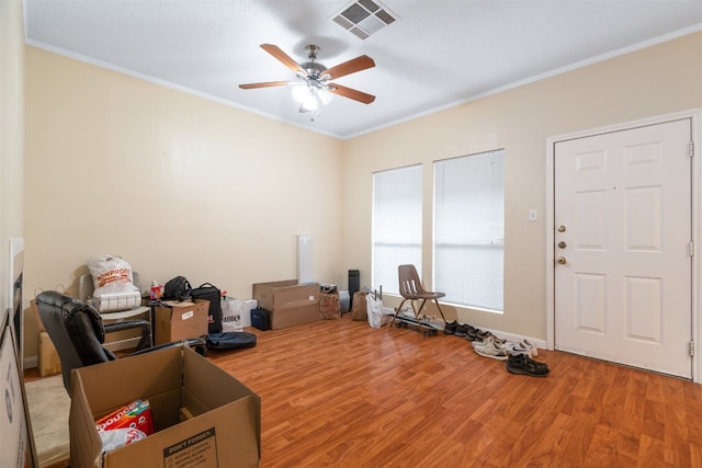 misc room with crown molding, hardwood / wood-style flooring, and ceiling fan