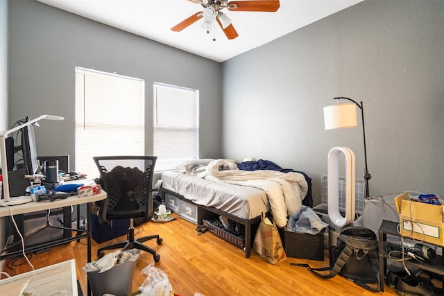 bedroom featuring ceiling fan and light hardwood / wood-style flooring