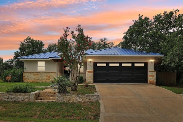 view of front of property with a lawn and a garage