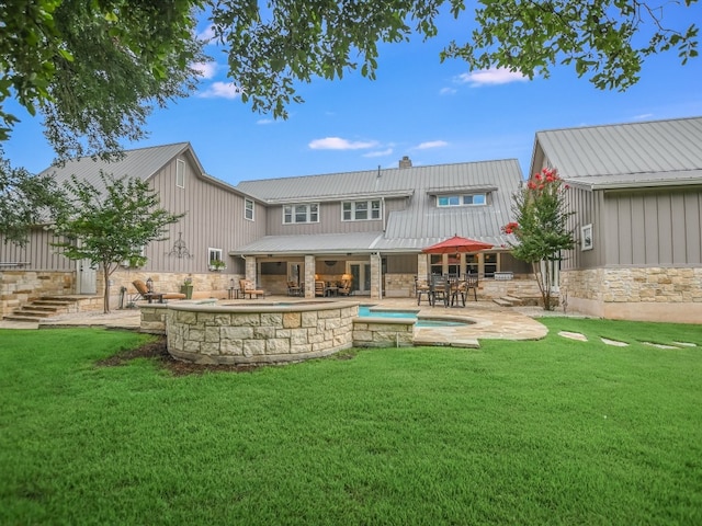 back of property featuring a lawn and a patio