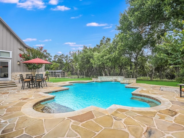 view of pool with a patio area and pool water feature