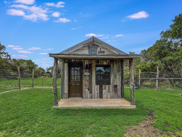 view of outbuilding with a lawn