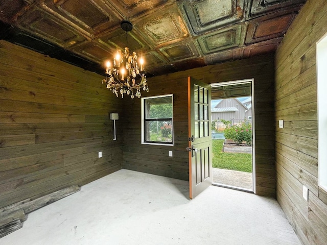 interior space featuring a chandelier, wooden walls, and coffered ceiling