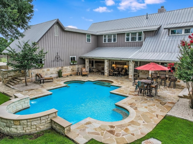 view of swimming pool with an outdoor bar and a patio area