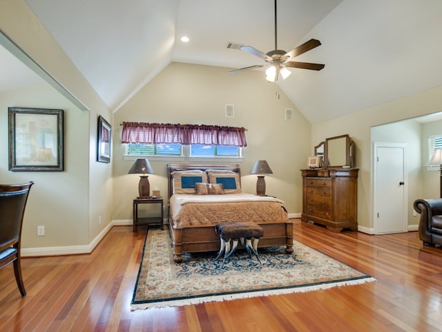 bedroom featuring wood-type flooring, vaulted ceiling, and ceiling fan