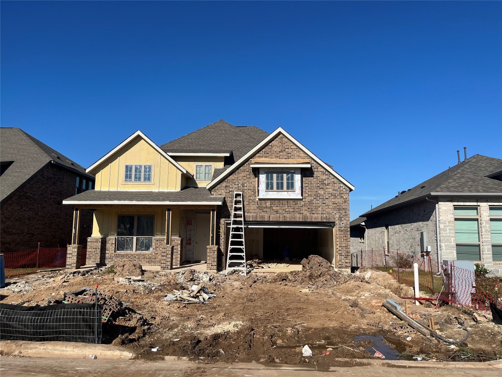 view of front of property featuring a garage and covered porch