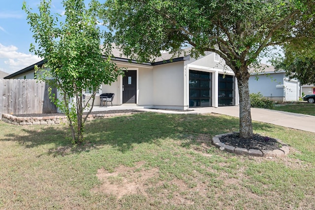 ranch-style house with a front yard and a garage