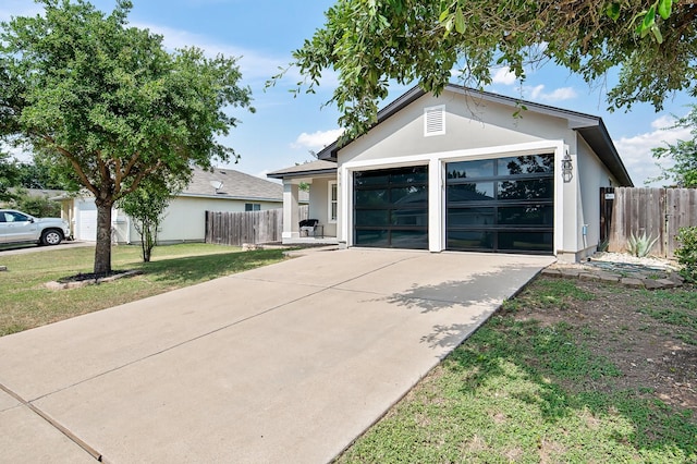 view of front of house featuring a front yard and a garage