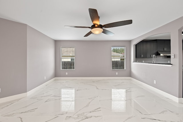 unfurnished room with ceiling fan