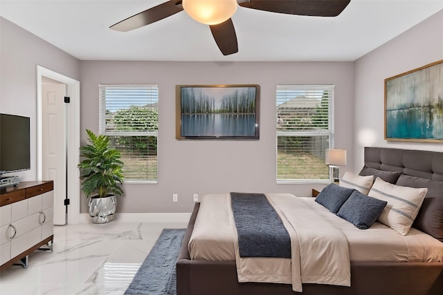 bedroom with ceiling fan and multiple windows