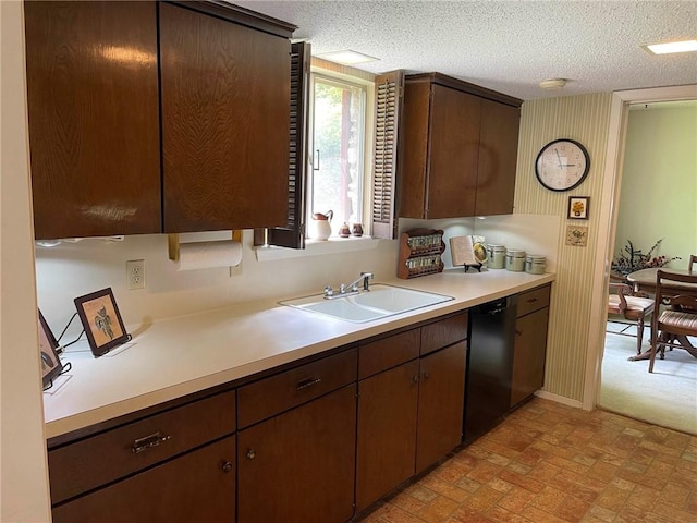 kitchen featuring dark brown cabinets, black dishwasher, and sink