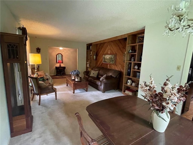 living room with a textured ceiling, light colored carpet, and wood walls