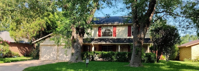 view of front facade with a garage and a front lawn