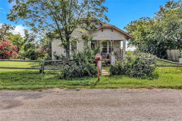 view of front of home featuring covered porch and a front yard