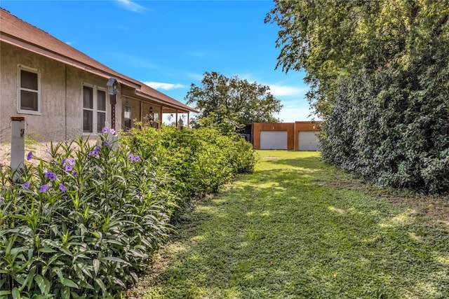 view of yard featuring an outbuilding and a garage