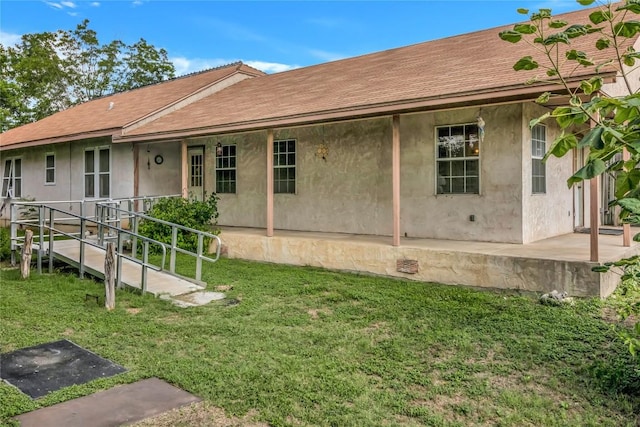 rear view of property with a lawn