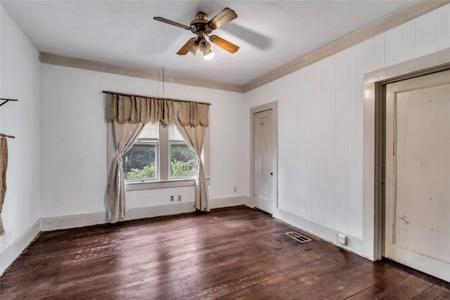 empty room with ceiling fan and dark wood-type flooring