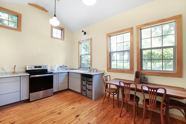 kitchen with light hardwood / wood-style flooring, light stone countertops, gray cabinets, electric stove, and lofted ceiling