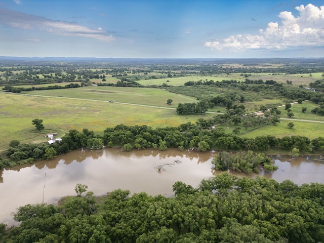 birds eye view of property featuring a water view and a rural view