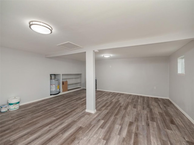 basement with gas water heater and hardwood / wood-style flooring