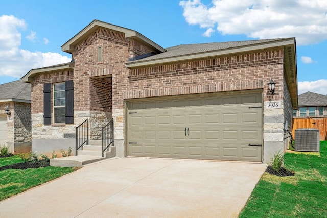 view of front of house featuring a front lawn and central AC