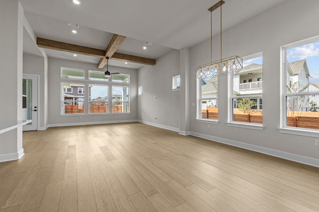 unfurnished dining area with light wood-type flooring, a notable chandelier, and beam ceiling