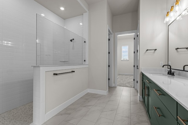 bathroom with vanity and a tile shower