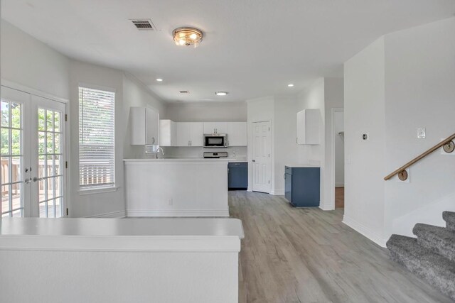 3917 Canyon Glen Cir, Austin, TX 78732 - kitchen with sink, french doors, white cabinets, and light wood-type flooring