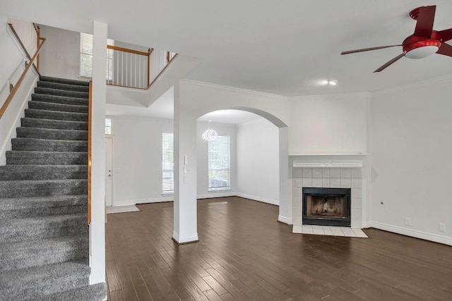 3917 Canyon Glen Cir, Austin, TX 78732 - unfurnished living room with a tile fireplace, ceiling fan, dark hardwood / wood-style floors, and ornamental molding