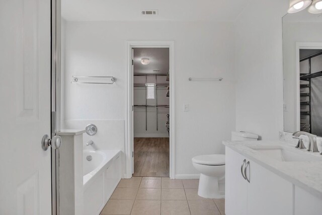 3917 Canyon Glen Cir, Austin, TX 78732 - bathroom featuring a tub to relax in, tile patterned flooring, vanity, and toilet
