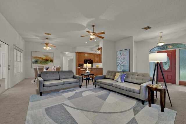 carpeted living room featuring a textured ceiling