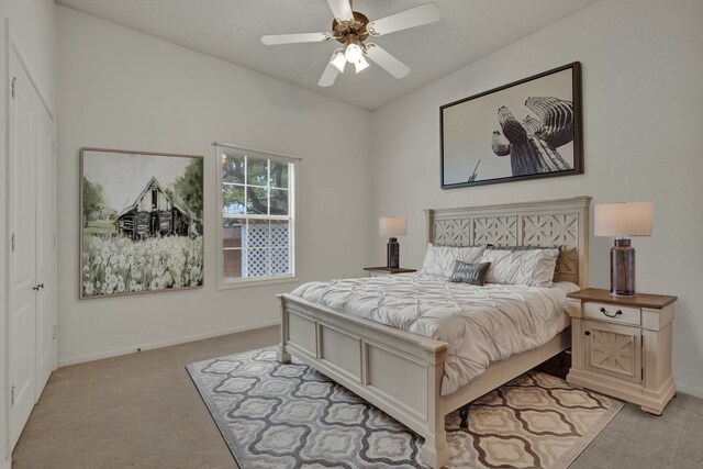 bedroom featuring ceiling fan and light carpet