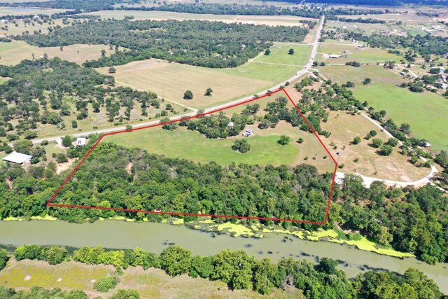 drone / aerial view featuring a rural view and a water view