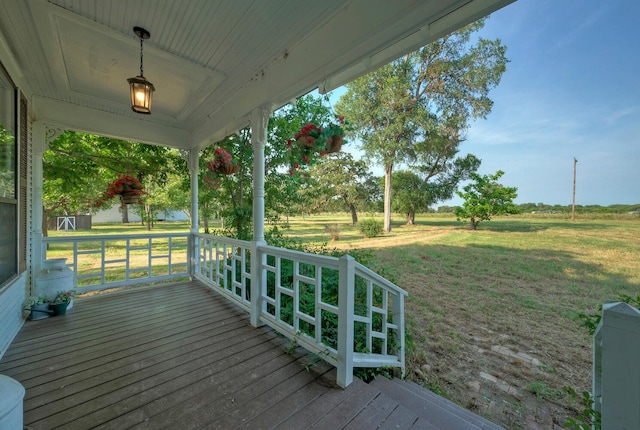 wooden terrace with a yard and covered porch