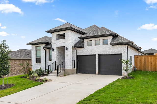 view of front of home featuring a front lawn and a garage