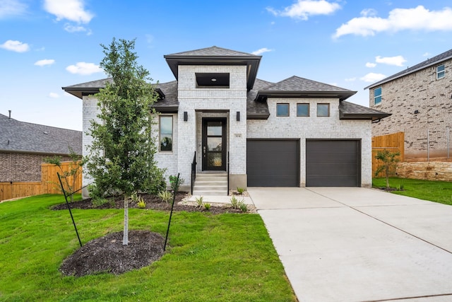 prairie-style home with a garage and a front yard