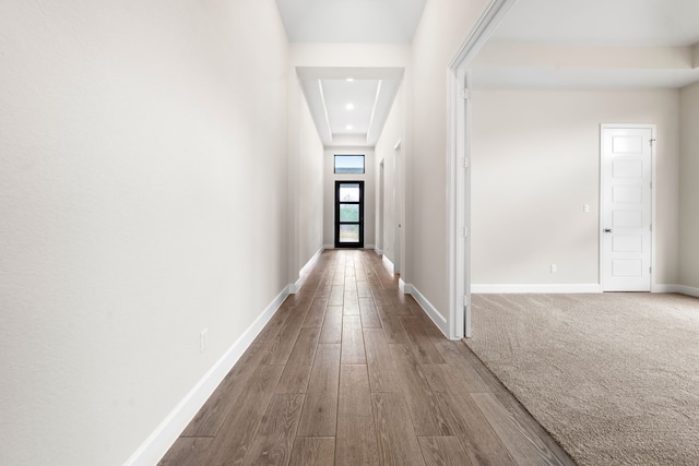 hallway with hardwood / wood-style flooring