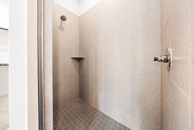 bathroom with a tile shower