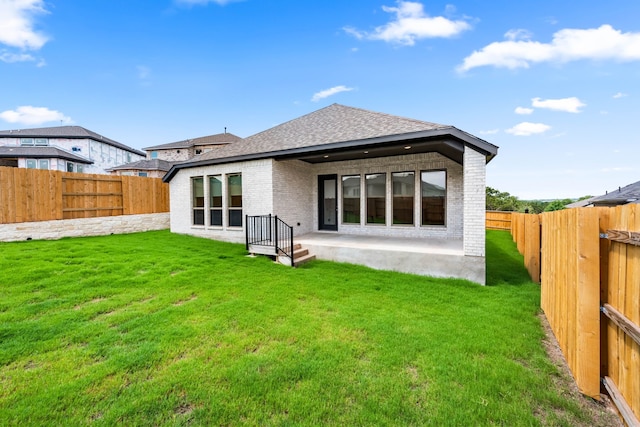 back of house featuring a yard