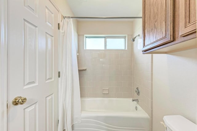 bathroom with toilet and shower / bath combo