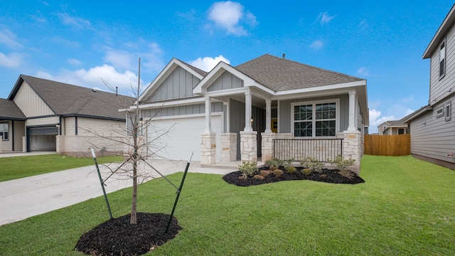 craftsman inspired home featuring a garage, covered porch, and a front yard