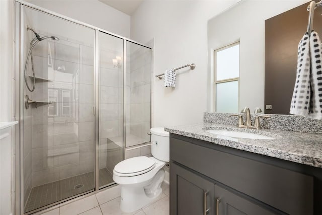 bathroom featuring tile patterned floors, vanity, walk in shower, and toilet