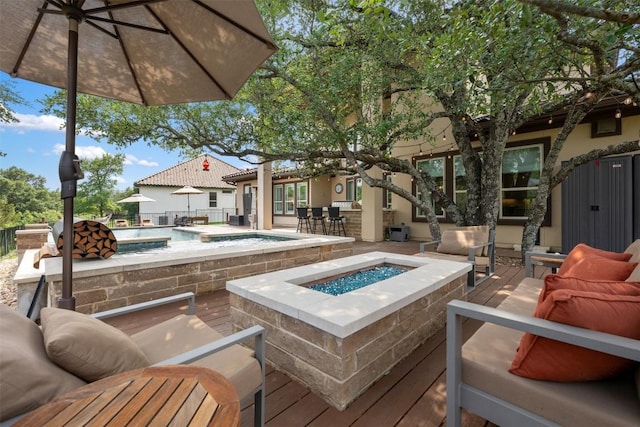 view of pool with a patio area and an outdoor living space with a fire pit