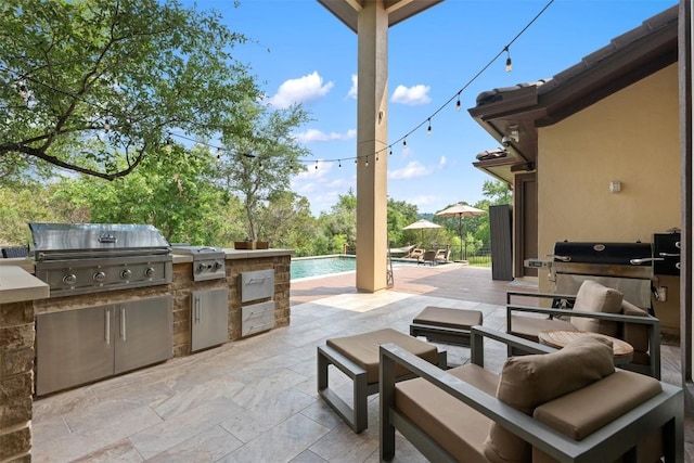 view of patio featuring area for grilling and exterior kitchen