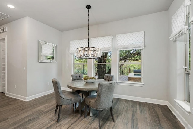 dining space featuring a chandelier and dark hardwood / wood-style floors